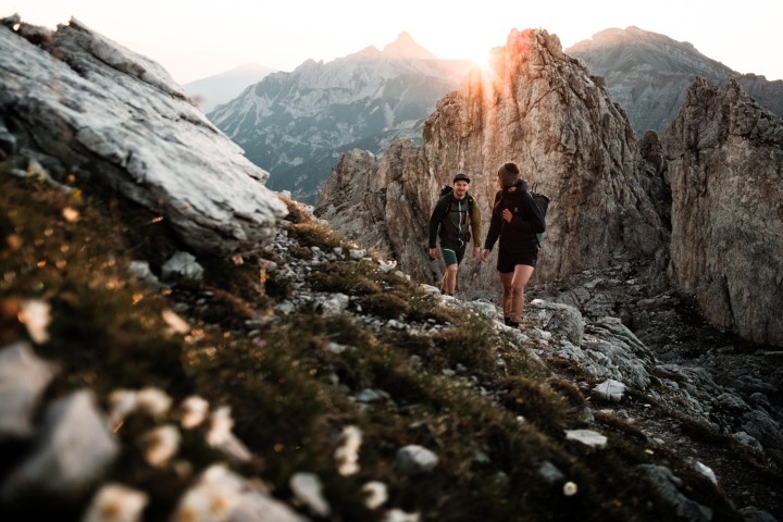 Stubai Valley, Tyrol - Mountain panorama and hikers at sunrise
